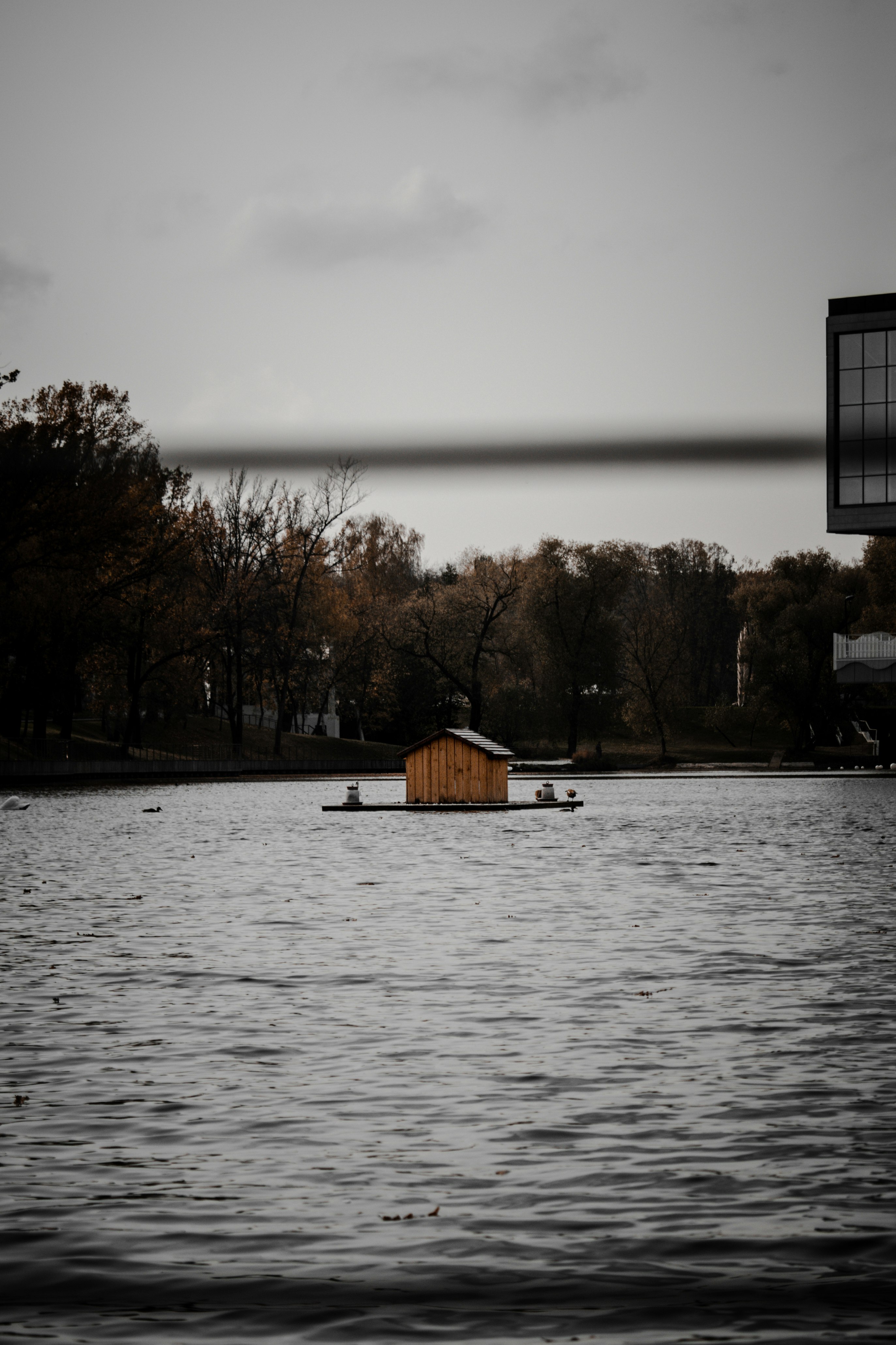 brown wooden house on body of water during daytime